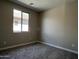 Inviting bedroom featuring a large window and plush carpeting at 17482 W Fulton St, Goodyear, AZ 85338