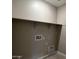 Practical laundry room with ample space for washer and dryer hookups at 17482 W Fulton St, Goodyear, AZ 85338
