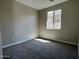 Cozy bedroom with neutral walls, carpet flooring, and natural light from a bright window at 17488 W Fulton St, Goodyear, AZ 85338