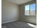 Bright and airy bedroom with a large window and plush carpeting at 17488 W Fulton St, Goodyear, AZ 85338