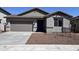 Charming single-story home featuring a neutral-toned exterior, a two-car garage, and low maintenance desert landscaping at 17488 W Fulton St, Goodyear, AZ 85338