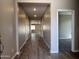 Inviting hallway featuring wood-look tile floors leading to other rooms at 17488 W Fulton St, Goodyear, AZ 85338
