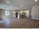 Open-concept kitchen with white cabinetry, stainless steel appliances, and a center island, seamlessly flowing into the living area at 17488 W Fulton St, Goodyear, AZ 85338