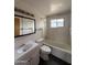 Clean bathroom with a white vanity, tiled shower-tub combo, and ample lighting at 1807 W Hazelwood St, Phoenix, AZ 85015