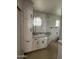 Compact bathroom featuring built-in storage and a functional layout at 1807 W Hazelwood St, Phoenix, AZ 85015