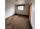 Simple bedroom featuring natural light, carpet, and a closet for convenient storage at 1807 W Hazelwood St, Phoenix, AZ 85015