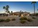Desert backyard with mature landscaping, covered patio and golf course views at 19541 N Rim Dr, Surprise, AZ 85374