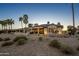 Expansive backyard offering mature desert landscaping, a covered patio, and serene surroundings at 19541 N Rim Dr, Surprise, AZ 85374