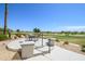 Back patio boasts a stunning golf course view with an outdoor dining area at 19541 N Rim Dr, Surprise, AZ 85374
