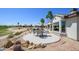Backyard with lush landscaping, a charming patio, and a scenic golf course backdrop at 19541 N Rim Dr, Surprise, AZ 85374