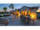 Beautiful backyard with patio, dining set, and adjacent lounge area, perfect for entertaining at 19541 N Rim Dr, Surprise, AZ 85374