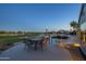 Spacious backyard patio with outdoor dining and relaxing lounge areas overlooking the golf course at 19541 N Rim Dr, Surprise, AZ 85374