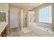 Bright bathroom with a soaking tub and a separate walk-in shower at 19541 N Rim Dr, Surprise, AZ 85374