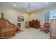 Comfortable bedroom featuring neutral walls, carpet, a ceiling fan, and shuttered windows at 19541 N Rim Dr, Surprise, AZ 85374