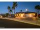 Beautifully landscaped home exterior with well-maintained front yard and spacious three-car garage at 19541 N Rim Dr, Surprise, AZ 85374