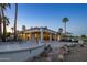 Elegant desert home with well-manicured landscaping, large patio, and multiple palm trees at 19541 N Rim Dr, Surprise, AZ 85374