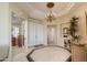 Elegant foyer featuring a tiled floor, chandelier, and inviting entryway with views to other rooms at 19541 N Rim Dr, Surprise, AZ 85374