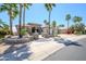 Well-manicured landscaping enhances this inviting home, complemented by mature palm trees at 19541 N Rim Dr, Surprise, AZ 85374
