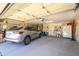 Spacious garage with epoxy floors, built-in cabinets, and a silver SUV parked inside at 19541 N Rim Dr, Surprise, AZ 85374