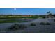 Scenic view of the lush golf course, providing a tranquil setting with a water feature at 19541 N Rim Dr, Surprise, AZ 85374