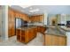 Spacious kitchen boasts generous cabinet space, granite counters, and island at 19541 N Rim Dr, Surprise, AZ 85374