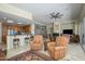 Expansive living area featuring a wet bar, fireplace, and access to the backyard at 19541 N Rim Dr, Surprise, AZ 85374