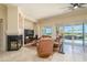 Relaxing living room with a fireplace, large television, and view of the landscaped backyard at 19541 N Rim Dr, Surprise, AZ 85374