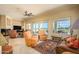 Inviting living room with sliding glass doors, a ceiling fan, and a picturesque view of the golf course at 19541 N Rim Dr, Surprise, AZ 85374