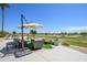 Inviting outdoor patio seating with umbrella and golf course views at 19541 N Rim Dr, Surprise, AZ 85374