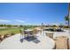 Inviting outdoor patio with dining and lounging areas overlooks a beautifully landscaped golf course for scenic relaxation at 19541 N Rim Dr, Surprise, AZ 85374