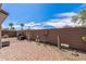 Paver backyard with desert landscaping, barbecue grill, and block wall at 20307 N Painted Sky Dr, Surprise, AZ 85374