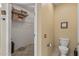 Clean bathroom with a toilet, walk-in closet with wire shelving, and neutral paint at 20307 N Painted Sky Dr, Surprise, AZ 85374
