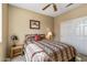 Comfortable bedroom featuring a ceiling fan for climate control and warm lighting at 20307 N Painted Sky Dr, Surprise, AZ 85374