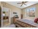 Bedroom with a window, closet, dresser and view of the living room at 20307 N Painted Sky Dr, Surprise, AZ 85374