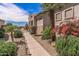 Beautifully landscaped pathway with gravel, small palms, desert plants and a view of the home's exterior at 20307 N Painted Sky Dr, Surprise, AZ 85374