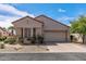 Exterior view of home showcasing the two-car garage, desert landscaping, and well-kept facade at 20307 N Painted Sky Dr, Surprise, AZ 85374