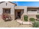 Charming home featuring a secure front door, small shrubbery, desert landscaping and a brick walkway at 20307 N Painted Sky Dr, Surprise, AZ 85374