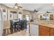 Bright eat-in kitchen area with sliding glass door to patio, granite countertops and stainless dishwasher at 20307 N Painted Sky Dr, Surprise, AZ 85374