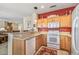 Well-lit kitchen featuring wood cabinets, granite countertops, white appliances, and an open layout at 20307 N Painted Sky Dr, Surprise, AZ 85374