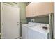 Functional laundry room featuring washer, dryer, and built-in storage cabinets at 20307 N Painted Sky Dr, Surprise, AZ 85374