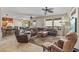 Spacious living room features tile flooring, ceiling fans, large windows, and comfortable furnishings at 20307 N Painted Sky Dr, Surprise, AZ 85374