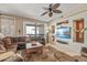 Comfortable living room with ceiling fan and views of the outside at 20307 N Painted Sky Dr, Surprise, AZ 85374