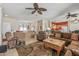 Open concept living room with tile floors, ceiling fans, and views of the kitchen and upstairs loft at 20307 N Painted Sky Dr, Surprise, AZ 85374