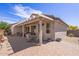 Extended covered patio with outdoor dining set and brick flooring for relaxed outdoor living at 20307 N Painted Sky Dr, Surprise, AZ 85374