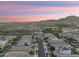 An aerial view of a neighborhood featuring beautiful landscaping and mountain views at 20607 W Point Ridge Rd, Buckeye, AZ 85396