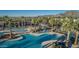 Aerial view of community pools, BBQ, lounging, and amenities with mountains in the distance at 20607 W Point Ridge Rd, Buckeye, AZ 85396
