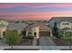 Aerial view of a beautiful home with a well-manicured front yard, paver driveway, and elegant turret design at 20607 W Point Ridge Rd, Buckeye, AZ 85396