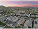 An aerial view captures a neighborhood against the backdrop of a mountain range at 20607 W Point Ridge Rd, Buckeye, AZ 85396