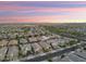 A beautiful sunset casts over a neighborhood and its stunning desert mountain views at 20607 W Point Ridge Rd, Buckeye, AZ 85396
