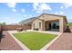 Charming backyard featuring a well-manicured lawn, stone pavers, and cozy patio seating at 20607 W Point Ridge Rd, Buckeye, AZ 85396